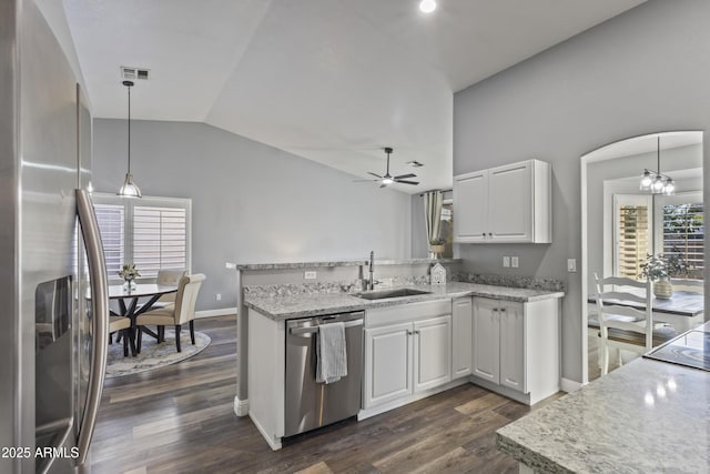 kitchen featuring a sink, dark wood-style flooring, appliances with stainless steel finishes, and vaulted ceiling