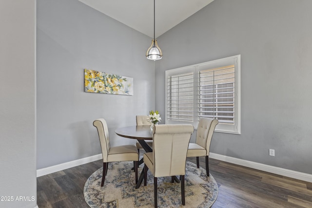 dining room with baseboards, wood finished floors, and high vaulted ceiling