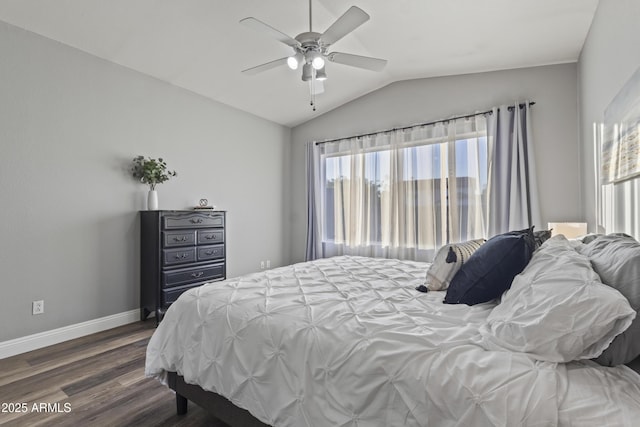 bedroom with baseboards, a ceiling fan, dark wood-style flooring, and vaulted ceiling
