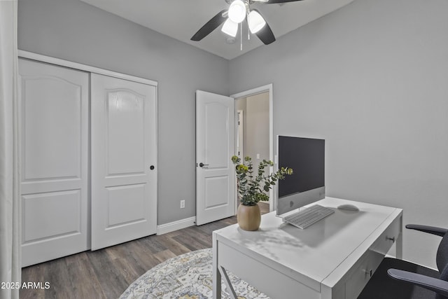 office space featuring baseboards, a ceiling fan, and wood finished floors