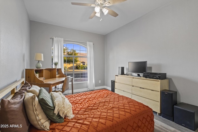 bedroom with baseboards, a ceiling fan, and wood finished floors
