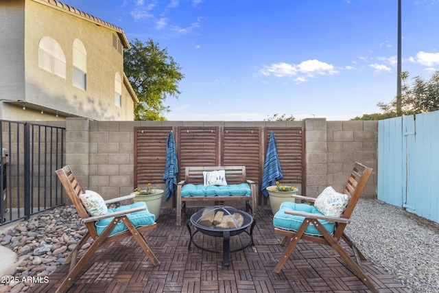 view of patio with fence private yard and a fire pit
