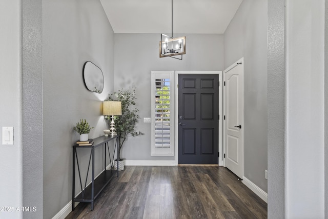 entryway featuring baseboards, wood finished floors, and a notable chandelier