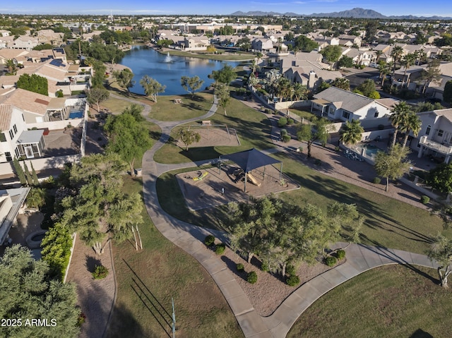 drone / aerial view featuring a residential view and a water and mountain view