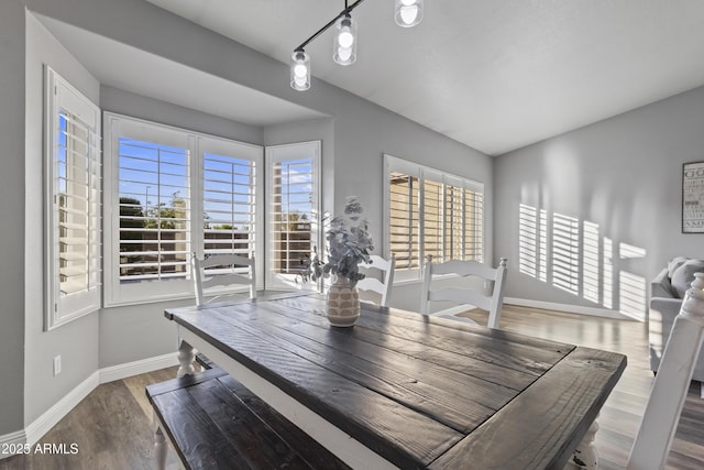 dining room with baseboards and wood finished floors