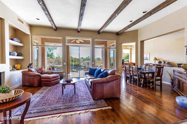 living area featuring plenty of natural light, visible vents, built in features, and wood-type flooring