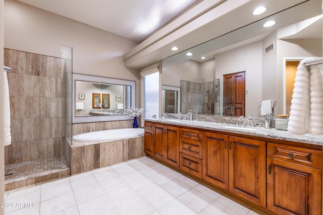 full bathroom featuring double vanity, visible vents, tiled shower, a garden tub, and a sink