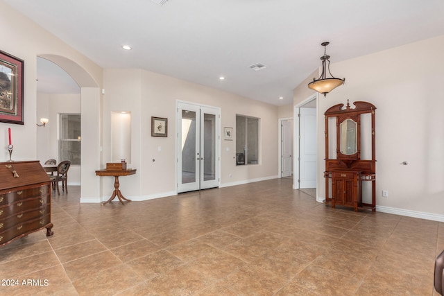 tiled empty room with french doors