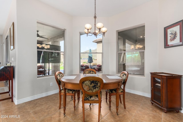 dining room featuring ceiling fan with notable chandelier and light tile patterned floors