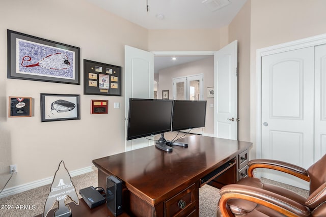 home office with carpet floors and french doors