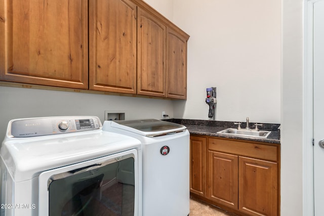 laundry area with washer and clothes dryer, sink, and cabinets