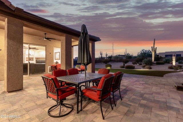 patio terrace at dusk featuring ceiling fan