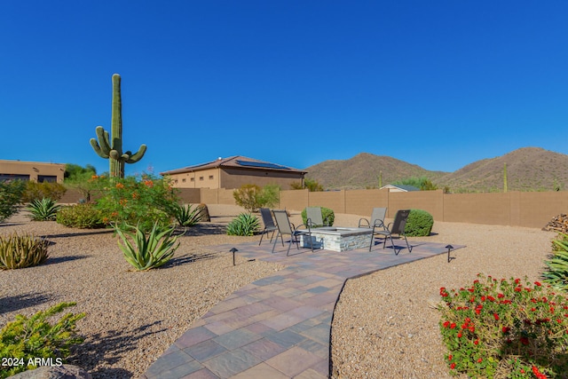 view of patio featuring a mountain view and a fire pit