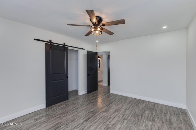 2501 E Campbell Ave, Phoenix, AZ 85016 - empty room with a ceiling fan, a barn door, wood finished floors, and recessed lighting