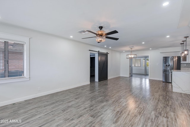 2501 E Campbell Ave, Phoenix, AZ 85016 - unfurnished living room with a barn door, recessed lighting, wood finished floors, a ceiling fan, and baseboards