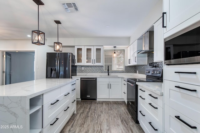 2501 E Campbell Ave, Phoenix, AZ 85016 - kitchen featuring black appliances, a sink, wall chimney exhaust hood, decorative backsplash, and glass insert cabinets