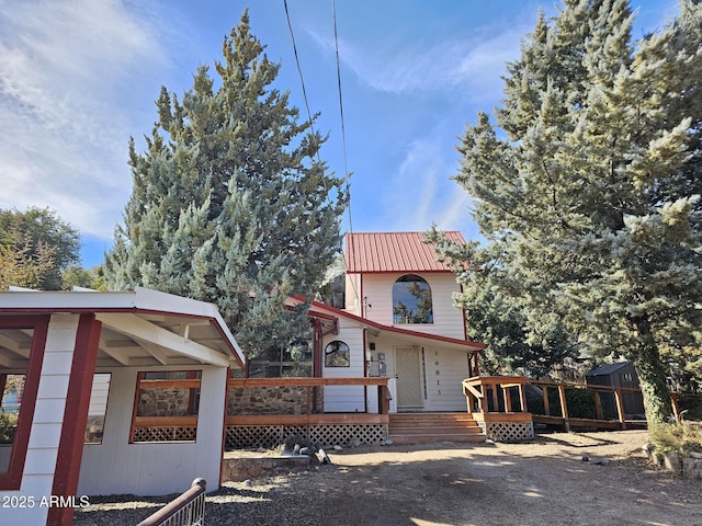 view of property exterior with a wooden deck