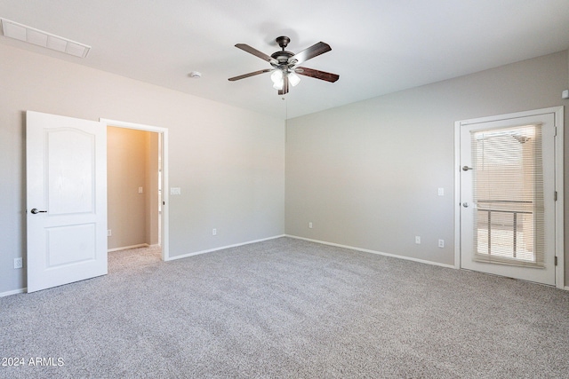 carpeted spare room featuring ceiling fan