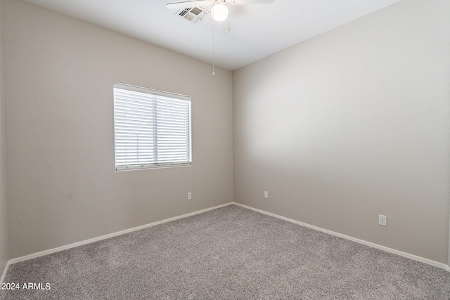 carpeted spare room featuring ceiling fan