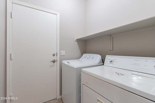 washroom featuring separate washer and dryer and light tile patterned floors