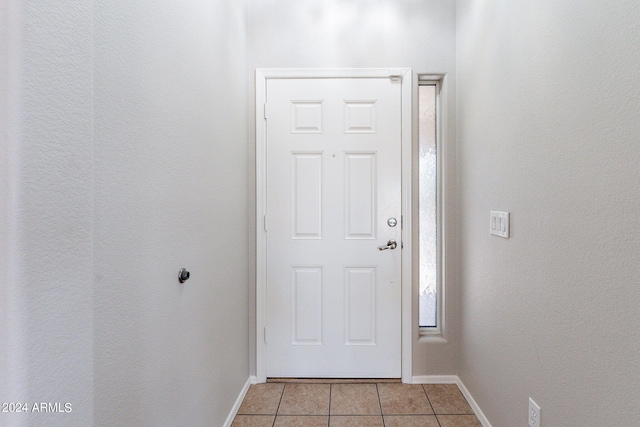 doorway to outside featuring light tile patterned flooring