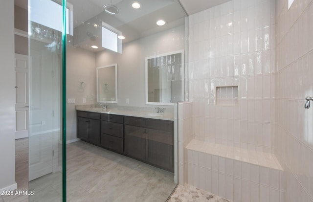 bathroom with a shower and vanity