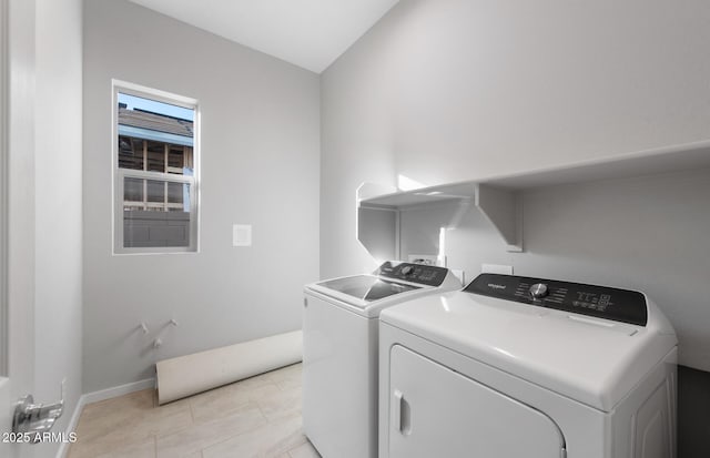 laundry room featuring light tile patterned flooring and washing machine and clothes dryer