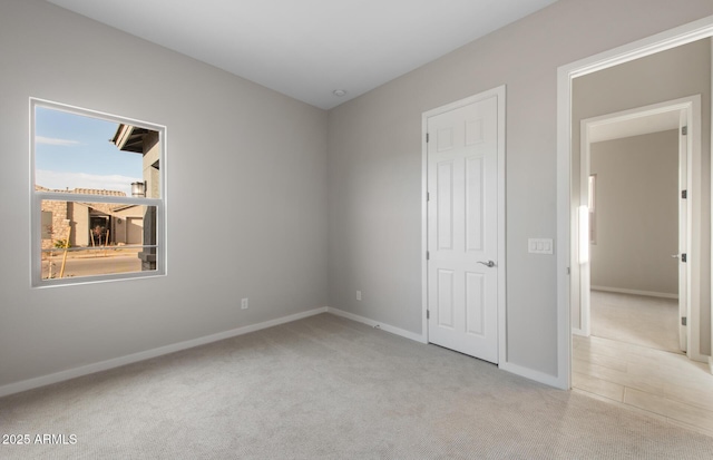 unfurnished bedroom with light colored carpet