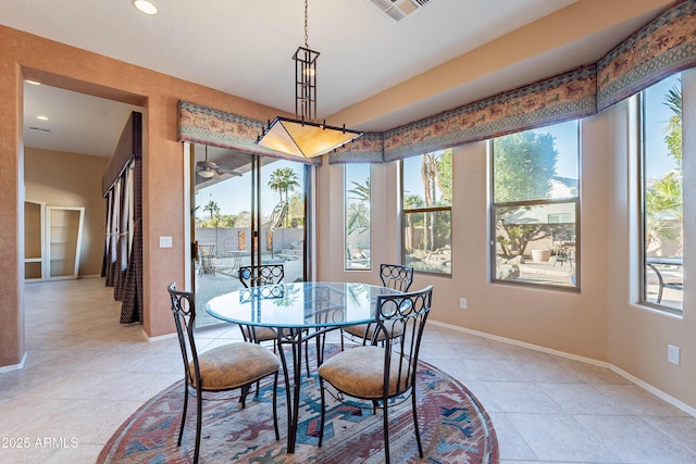 dining area with a wealth of natural light and light tile patterned floors