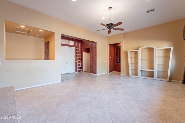 tiled empty room featuring ceiling fan