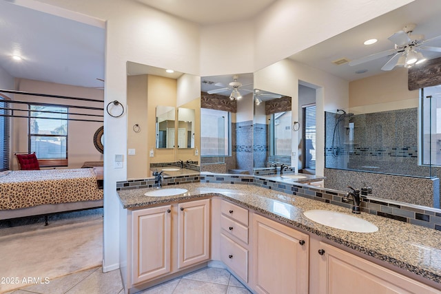 bathroom with tasteful backsplash, a tile shower, vanity, ceiling fan, and tile patterned flooring