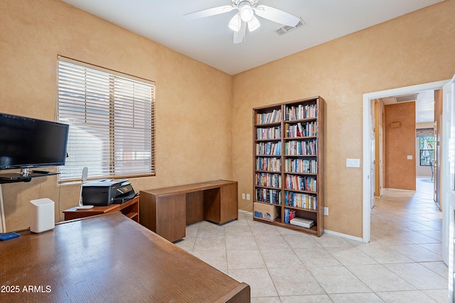 tiled office featuring ceiling fan