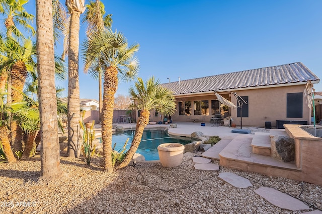 view of pool with pool water feature and a patio area