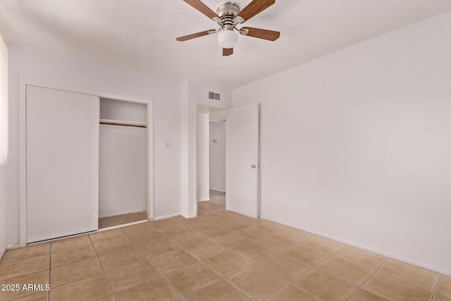 9847 N 11th Ave Unit 2, Phoenix, AZ 85021 - unfurnished bedroom with a closet, light tile patterned floors, and ceiling fan
