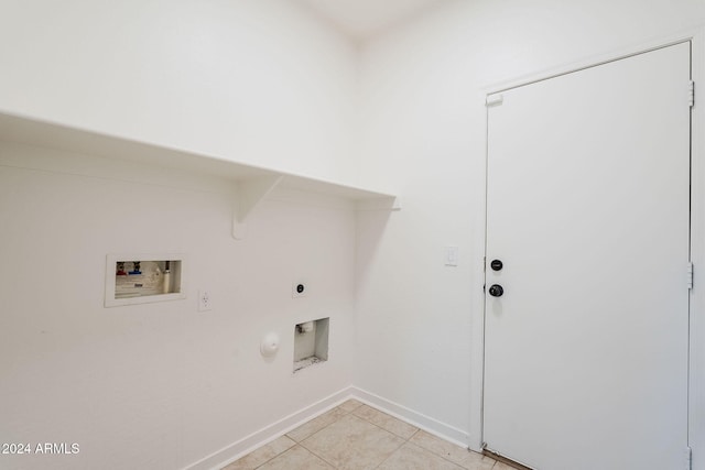 washroom featuring electric dryer hookup, hookup for a gas dryer, light tile patterned floors, and hookup for a washing machine