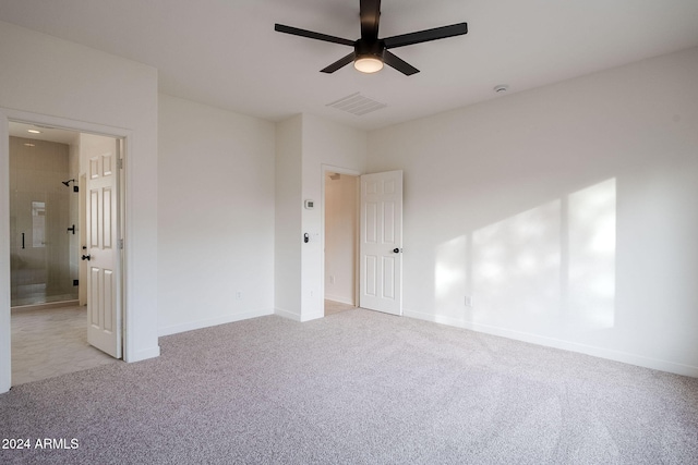 carpeted spare room featuring ceiling fan