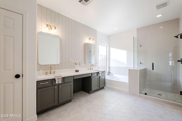 bathroom with separate shower and tub and vanity