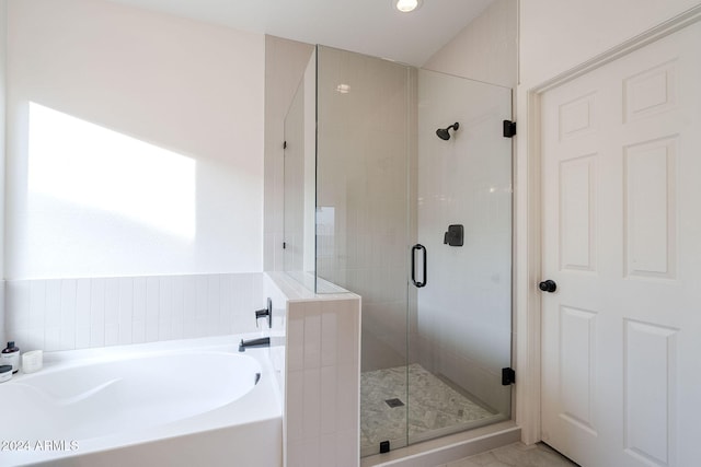 bathroom featuring shower with separate bathtub