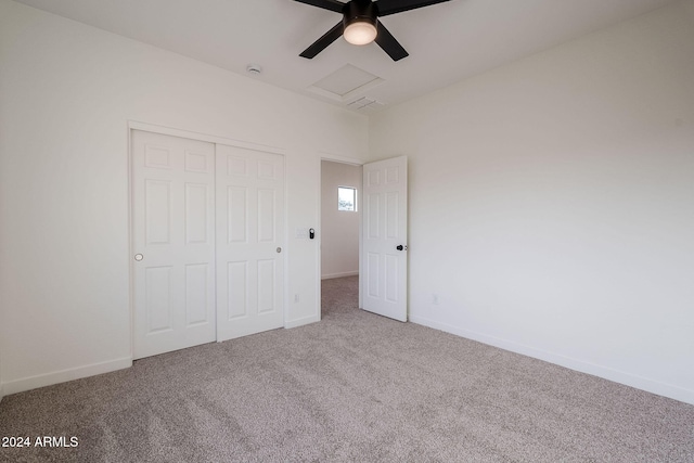 unfurnished bedroom with carpet, a closet, and ceiling fan