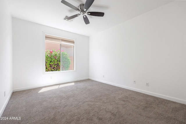 carpeted spare room with ceiling fan