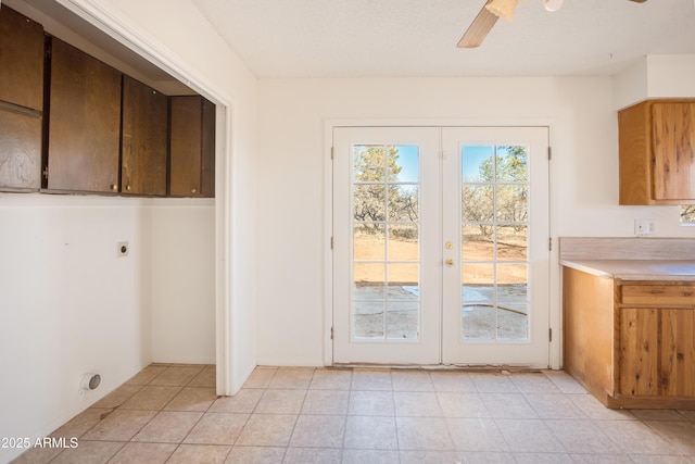 washroom with french doors, ceiling fan, hookup for an electric dryer, and light tile patterned flooring