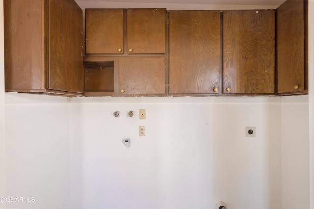 washroom featuring cabinets, gas dryer hookup, and hookup for an electric dryer