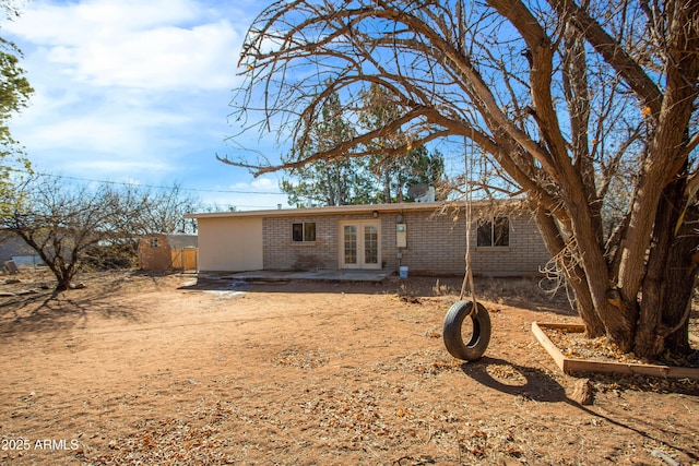 back of house with french doors and a patio
