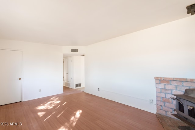 interior space featuring light hardwood / wood-style flooring and a wood stove
