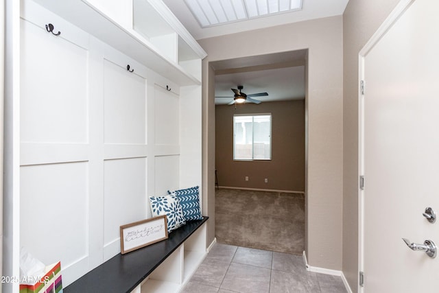 mudroom with ceiling fan and light tile patterned floors