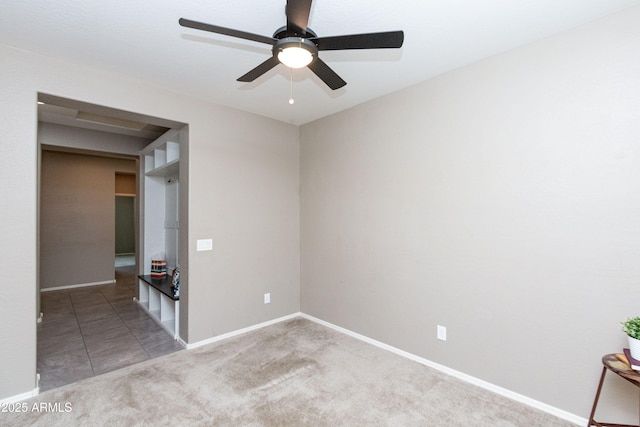 carpeted empty room featuring ceiling fan