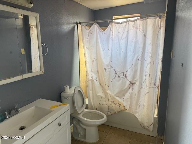 full bathroom with vanity, shower / tub combo, tile patterned flooring, and toilet