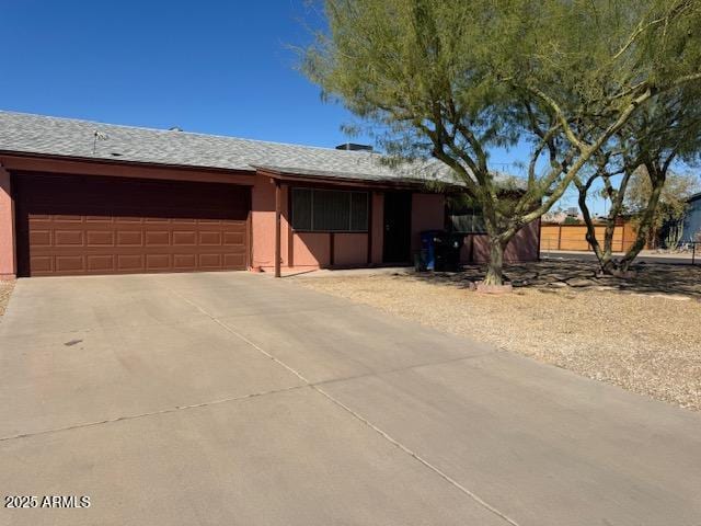 single story home featuring driveway and an attached garage