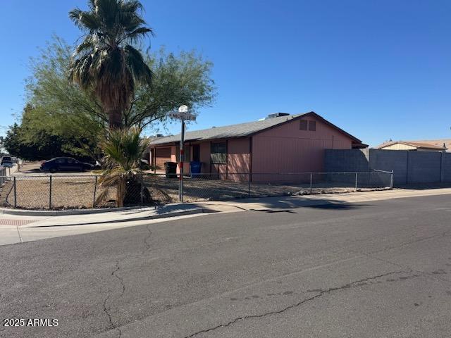 single story home with fence