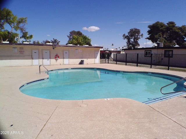 community pool featuring a patio area and fence